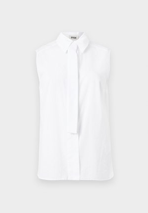 Bezrękawowa biała bluzka z zaostrzonym kołnierzykiem i ukrytymi frontowymi guzikami, wyposażona w wąski materiałowy pasek zwisający z przodu.
