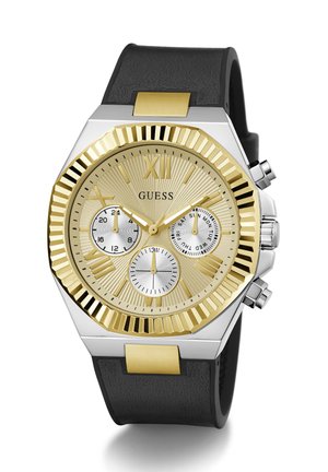 Gold and silver watch with a textured face, black rubber strap, chronograph features, and a hexagonal case design.