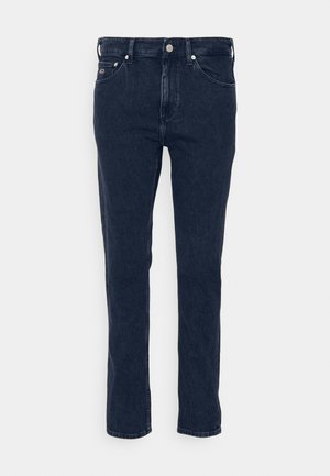 Mørkeblå denimjeans med rett ben, som har fem lommer, beltehempe og metallknapplukking. Glatt tekstur, minimal søm.