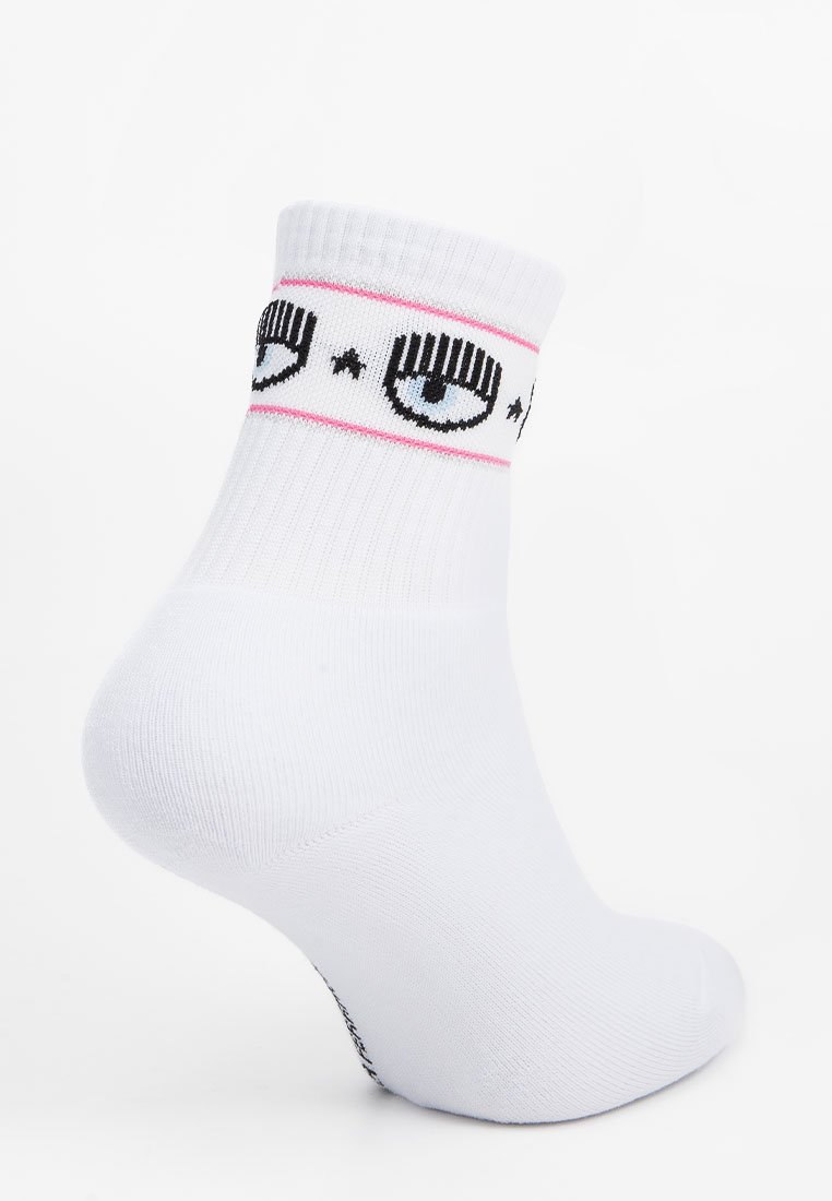 Calzino bianco alla caviglia con bordo a costine, decorato con un motivo a occhi nero e azzurro chiaro e una striscia rosa. Realizzato in materiale morbido ed elastico.