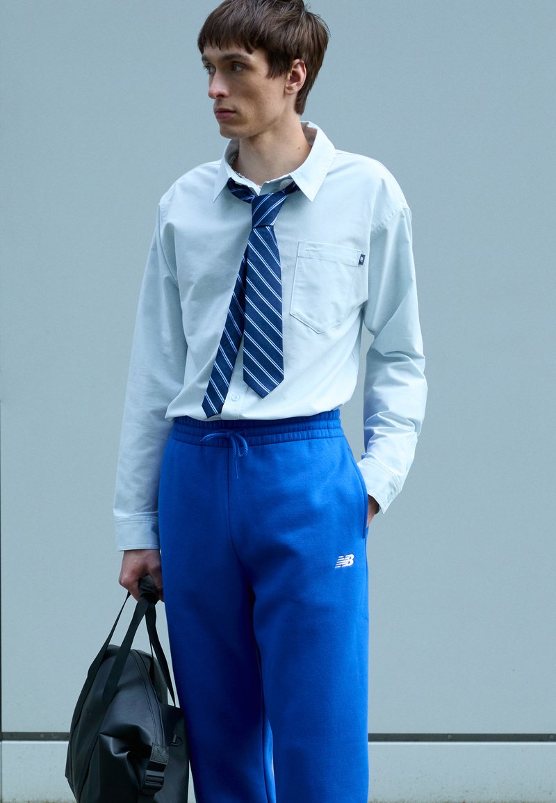 New Balance SPORT ESSENTIALS - Teplákové kalhoty - blue