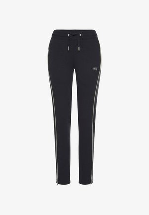 Black sweatpants with a drawstring waistband. Features contrasting white side stripes and logo detail on the left leg. Smooth fabric texture.