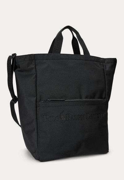 Must käekott kahe käepideme ja reguleeritava õlarihmaga, esiküljel lukuga tasku ning reljeefse Polo Ralph Laureni logoga.