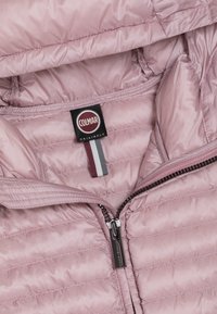 Pink padded jacket with diagonal quilting, zip closure, and a branded label featuring a tricolor accent. Smooth, shiny fabric.