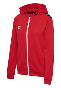 Roter Kapuzenpullover mit durchgehendem weißen Reißverschluss und gefütterter Kapuze. Merkmale schwarze Akzente an den Schultern und seitlichen Taschen. Hergestellt aus strukturiertem Stoff.
