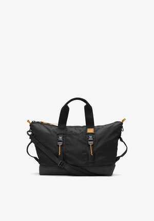 Bolso de viaje de nylon negro con acabados en cuero marrón, asas dobles en la parte superior, correa de hombro ajustable y cierre con cremallera. Presenta bolsillos laterales.