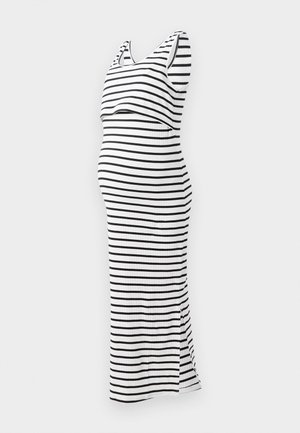 Robe de maternité rayée en noir et blanc, sans manches, avec une silhouette ajustée et une fente sur le côté, fabriquée en tissu côtelé.