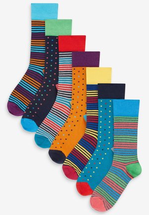 Chaussettes en coton assorties avec des rayures et des pois, dans des couleurs vives incluant le bleu, le vert, le rouge, l'orange et le marine. Bords et poignets texturés.