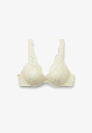 Soutien-gorge en dentelle de couleur crème clair avec des bonnets rembourrés, des bords festonnés et des bretelles réglables. Présente un motif floral et une fermeture à crochets.