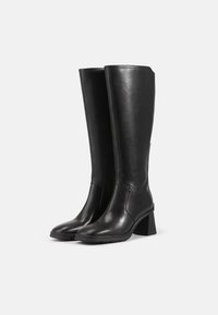 Black leather knee-high boots with a square block heel, smooth texture, rounded toe, and seam detailing along the sides.