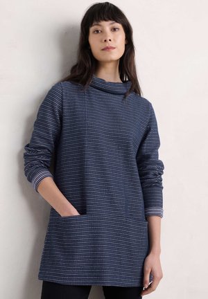 Navy tunic with a cowl neck, featuring a textured pattern, long sleeves with striped cuffs, and a front pocket.