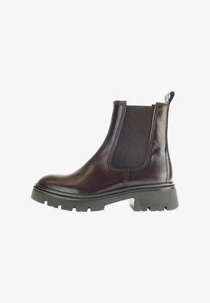 Bottines Chelsea en cuir marron avec des panneaux latéraux élastiques, un bout arrondi et une semelle en caoutchouc épaisse dotée de profondes rainures pour une bonne traction.