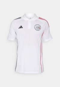 Hvid polo-shirt med sorte og røde striber på skuldrene. Har et emblem på brystet og en klassisk krave. Fremstillet af åndbart stof.