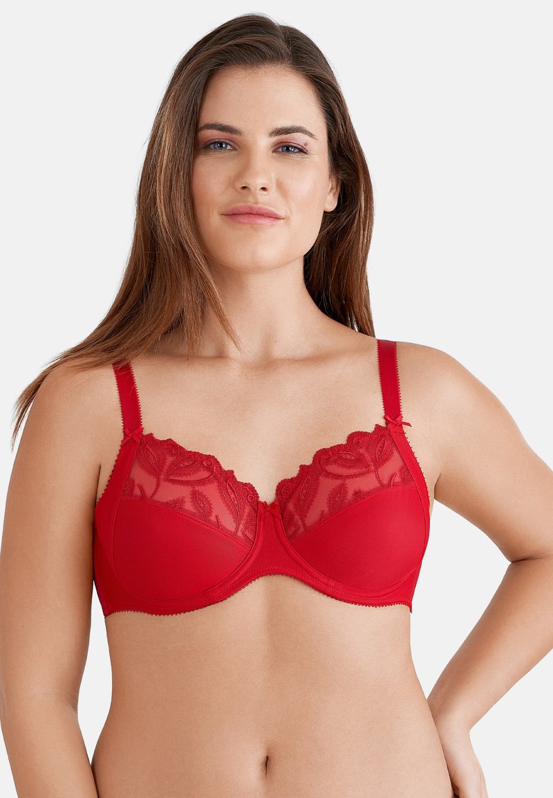 Rode beha met een doorschijnende kant bovenkant met bloempatronen, verstelbare bandjes en contrasterende afwerking langs de randen. Zachte stoftextuur.