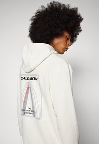 Salomon SAL BOW GRAPHIC HOODIE UNISEX - Pusa - sand