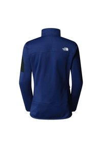 Námořnická modrá fleecová bunda s vysokým límcem, černými ramenními nášivkami a logem na zádech. Hladká textura a přiléhavý design.