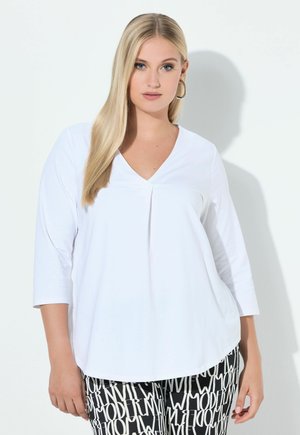 - Bluzka z długim rękawem