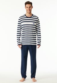 Langärmliges gestreiftes Schlafanzugoberteil in Marineblau und Weiß, mit rundem Halsausschnitt und kleinem Logo. Kombiniert mit einfarbigen Marineblauen Hosen. Weicher Stoff.