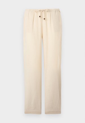 Lichtbeige, losvallende broek met elastische tailleband en trekkoord met twee houten kralen aan de uiteinden, afgebeeld tegen een effen achtergrond.