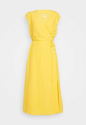Vestido midi amarillo con lunares blancos, mangas cortas tipo capa, botones laterales y cinturón de lazo en la cintura.