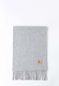 Grey wool scarf with fringed edges. Features a small, rectangular leather tag with embossed logo at the bottom right corner.