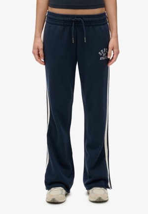 Navy sweatpants with a relaxed fit, elastic waistband, drawstring, and cream side stripes; features "Superdry Athletic" logo on the left thigh.