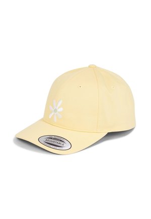 Yellow cap made of fabric with a curved brim. Features an embroidered white daisy design and an adjustable strap label.