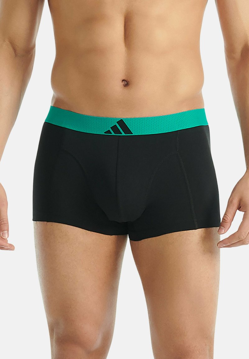 Boxer shorts noirs avec une ceinture élastique turquoise présentant un motif texturé et un accent logo noir. Tissu extensible confortable.