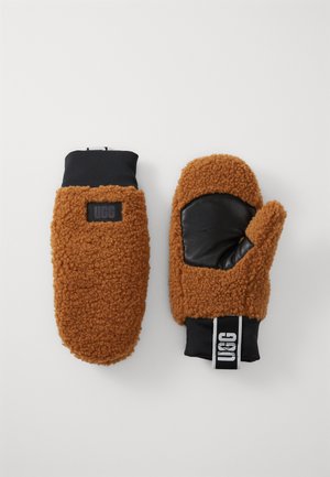 Brune fleecevotter med svart skinnpalme, med en tettsittende mansjett og en logotagg. Myk tekstur, avrundet form og fingerløs design.