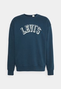 Námořnická modrá mikina vyrobená z bavlny, s volným střihem, kulatým výstřihem a bílým logem 'LEVI'S' ve zakřiveném designu přes hrudník.