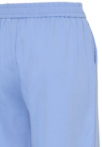 Svetlo modre lounge hlače iz gladkega blaga z elastičnim pasom in stranskimi žepi, z ohlapnim krojem in minimalnimi šivi.