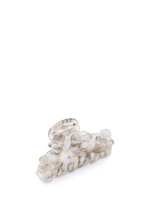 Clip per capelli in plastica trasparente con forme di fiori e piccoli rhinestones, dalla superficie liscia e in un colore chiaro e neutro.