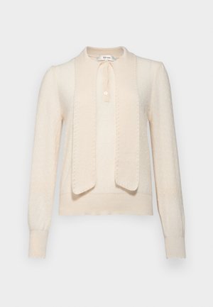 Pull en tricot couleur crème avec un col, fermeture à boutons et un panneau avant contrasté. Présente des motifs texturés et des poignets côtelés.