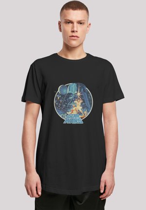 Black t-shirt featuring a colorful graphic design of a character, surrounded by stars and planets, with "STAR WARS" text at the bottom.