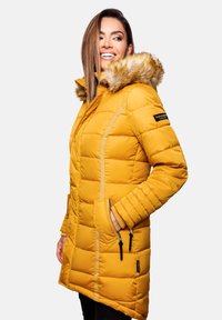 Yellow puffer jacket with a faux fur hood, vertical quilted design, side pockets, and contrasting zippers. Suitable for cold weather.