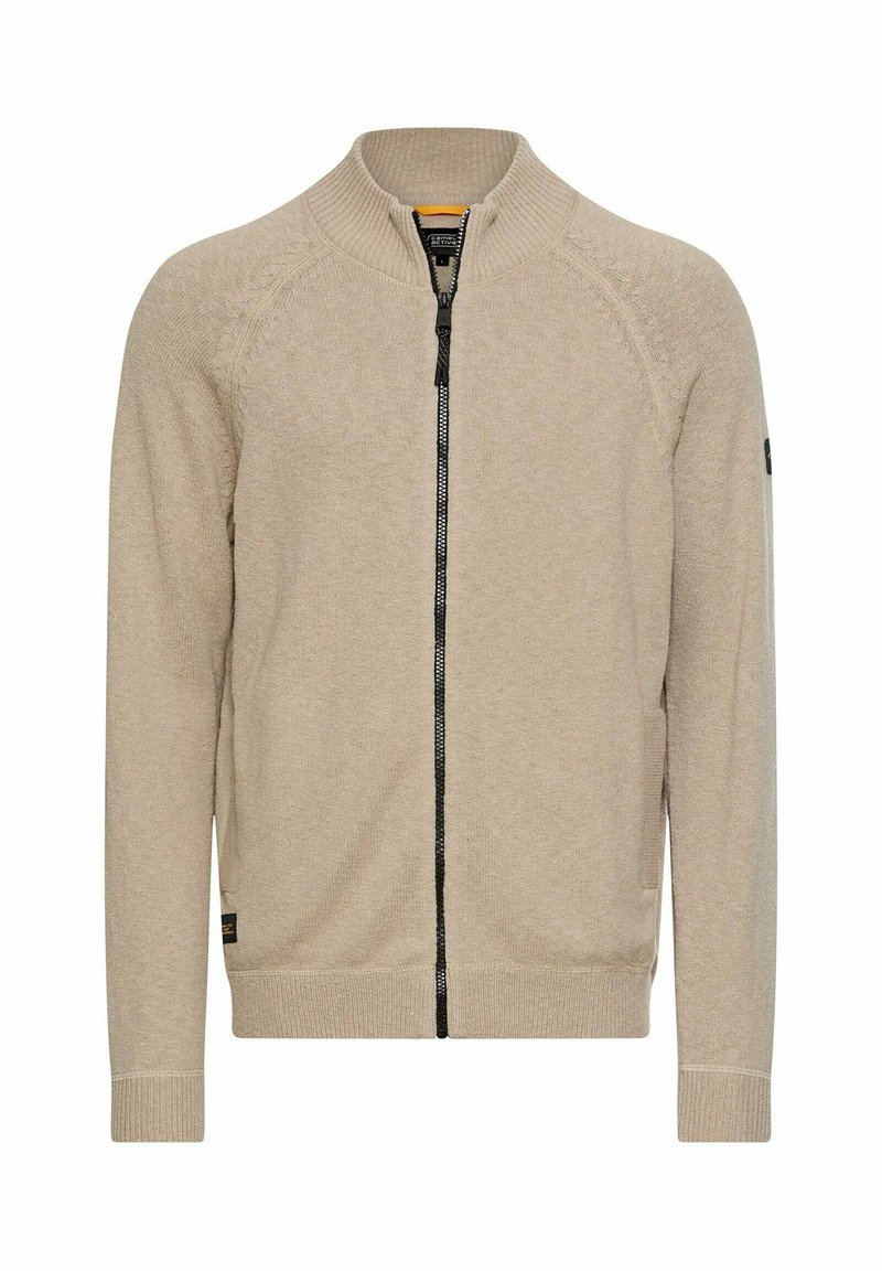 Lysebeige cardigan med lynlås i strikket stof, der har en ribbet krave, sort lynlås og sidelommer. Enkel design uden mønstre.