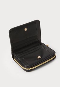 Black leather wallet with gold zipper, multiple card slots, and snap button closure, open to show interior compartments.