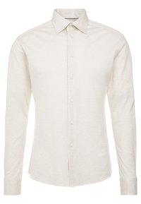 Camicia a manica lunga beige chiaro in cotone, con colletto classico, chiusura frontale con sei bottoni e maniche con polsini. Finitura semplice e texturizzata.