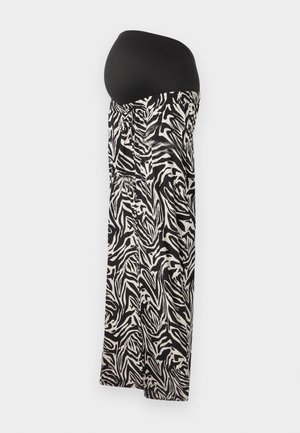 Juoda ir balta zebro rašto nėštumo sijonas su tampriu juodu juosmeniu, pasižymintis sukaupta detale liemenyje ir laisvu dizainu.