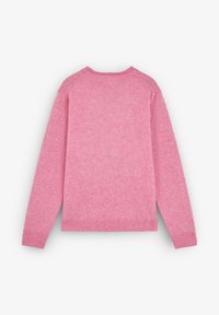 Pink sweater featuring a soft, textured knit, ribbed cuffs, and hem. The design includes raglan sleeves and a relaxed fit.