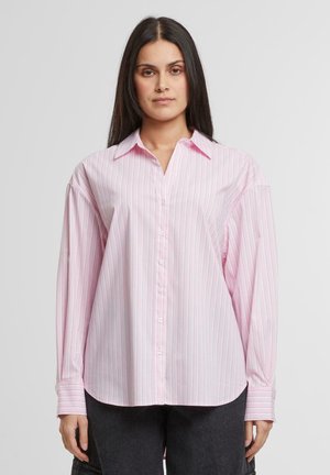 Light pink button-up shirt with vertical white stripes, long sleeves, a pointed collar, and a relaxed fit. Soft fabric with smooth texture.