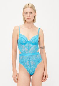 Bright blue lace bodysuit with a cut-out design, underwire cups, thin straps, and a high-waisted brief featuring floral patterns.