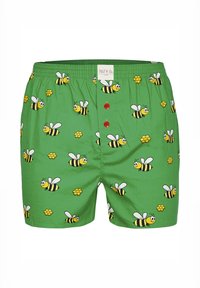 Groene boxershorts met een speels patroon van bijen en bloemen, voorzien van rode knopen en een elastische tailleband. Gemaakt van een gladde stof.