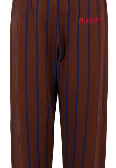 Bruine broek met verticale blauwe en donkerbruine strepen, voorzien van rode borduurwerk "M. RODINI" aan de bovenkant van de linkerkant.
