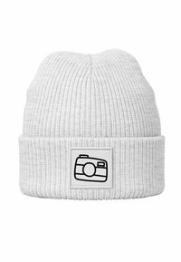 White knitted beanie with a ribbed texture, featuring a square patch displaying a simplistic camera graphic in black.