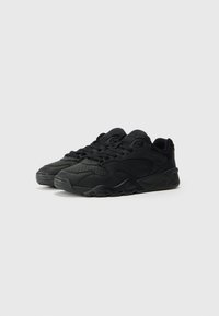 Black athletic sneakers with textured leather and mesh upper, featuring a rounded toe, thick rubber sole, and front lace closure.