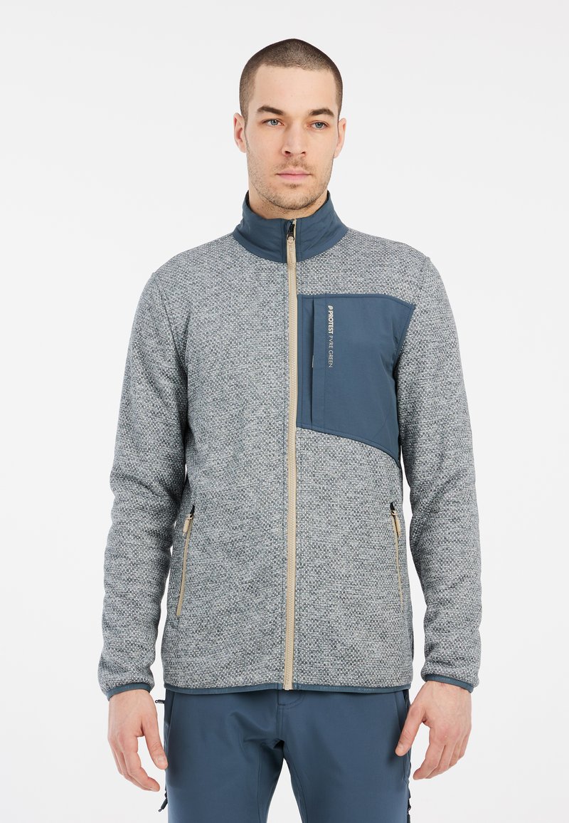 Grijze en marineblauwe fleecejas met een hoge kraag, textuurpatroon, rits aan de voorkant en borstzak. Voorzien van dubbele ritszakken aan de zijkanten.