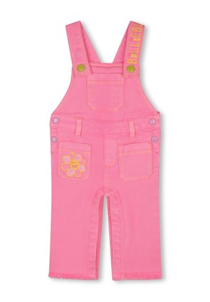 Salopette en jean rose avec bretelles ajustables, poche avant et deux poches arrière. Présente une broderie de fleurs jaunes et des franges au bas.