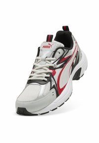 White and black athletic shoe with red accents, featuring a mesh upper, padded tongue, and textured rubber sole with a rounded edge.
