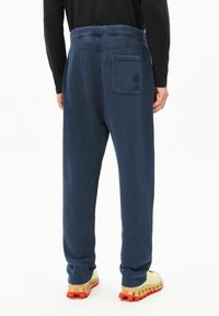 Donkerblauwe joggingbroek met een comfortabele pasvorm, elastische tailleband, achterzak met logodetail en geribbelde boorden bij de enkels.